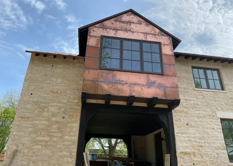 Copper metal panel facade on a stone building for Metal Roof Coating in Greenville